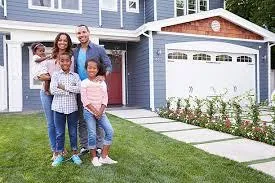 Happy Family in Front of Their New Home