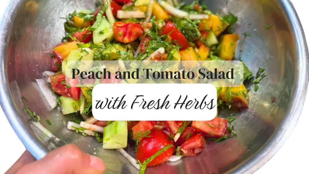 Fresh peach and tomato salad with cucumber and herbs in a bowl