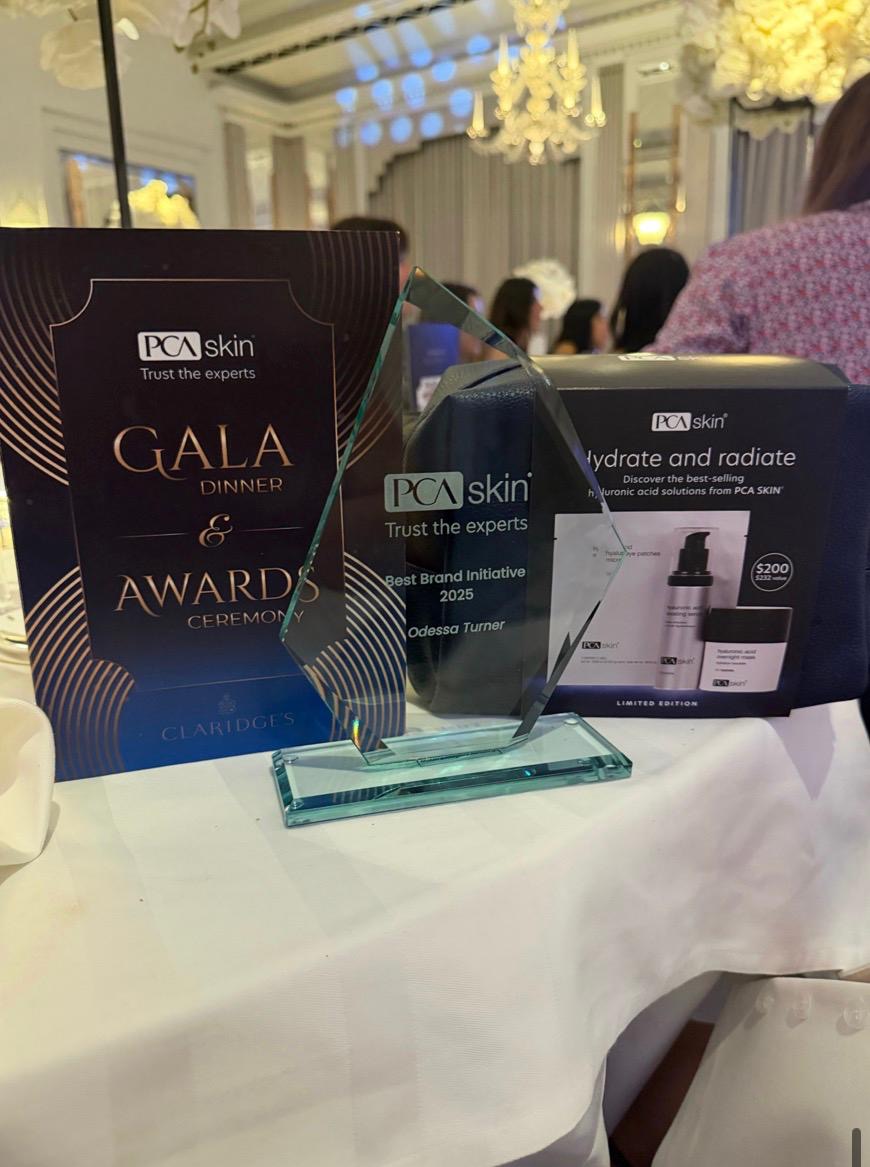 PCA Skin Best Brand Initiative 2025 award won by Odessa Turner at the PCA Skin Gala Dinner and Awards Ceremony held at Claridge’s London, alongside PCA Skin skincare products.