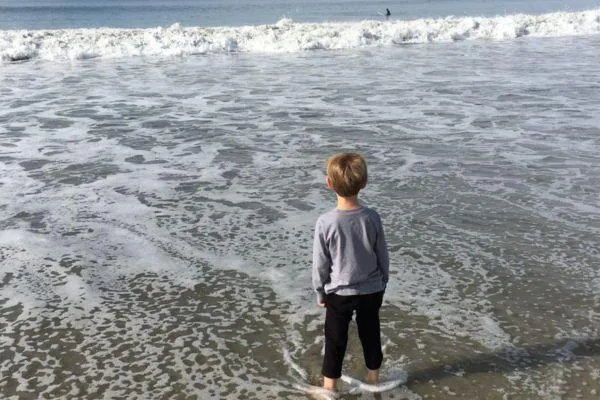 boy staring at the ocean