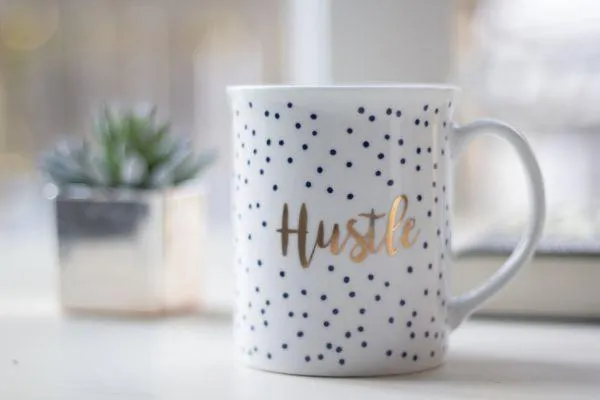 mug with the word hustle