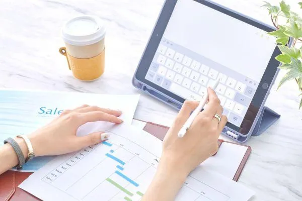 image of an ipad and sales documents