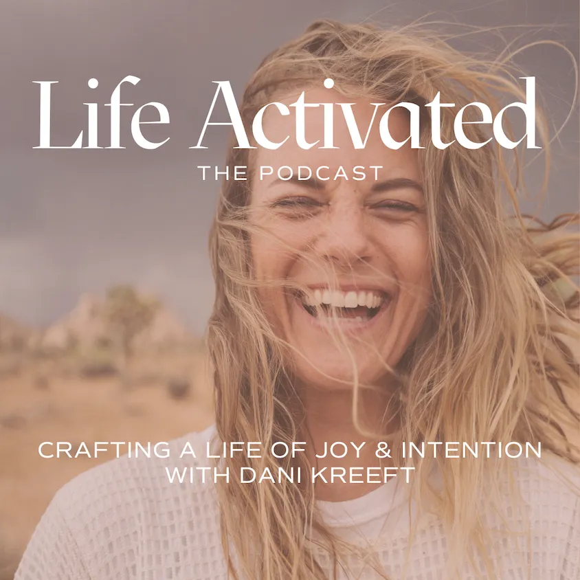 Woman with blonde hair laughing with eyes closed