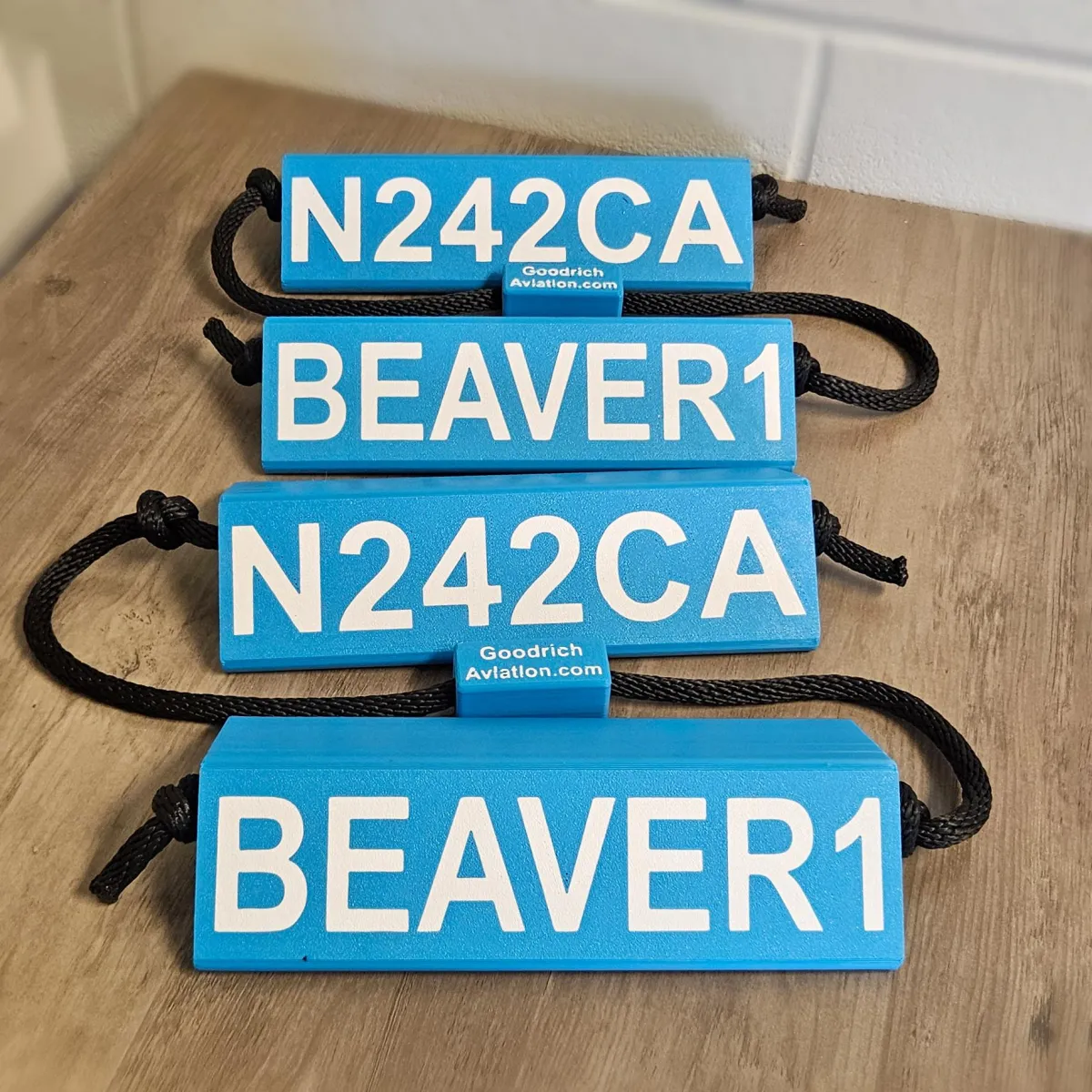 Light blue base white letters black rope