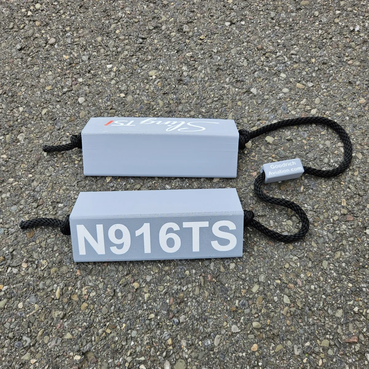 Light gray base white letters black rope