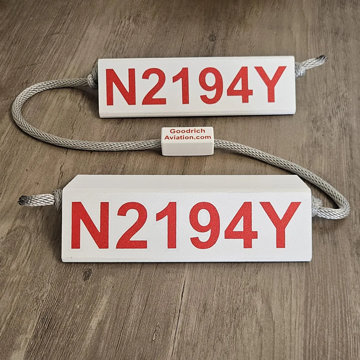 White base red letters gray rope