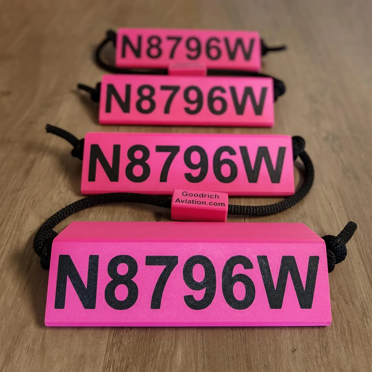 Pink base black letters black rope