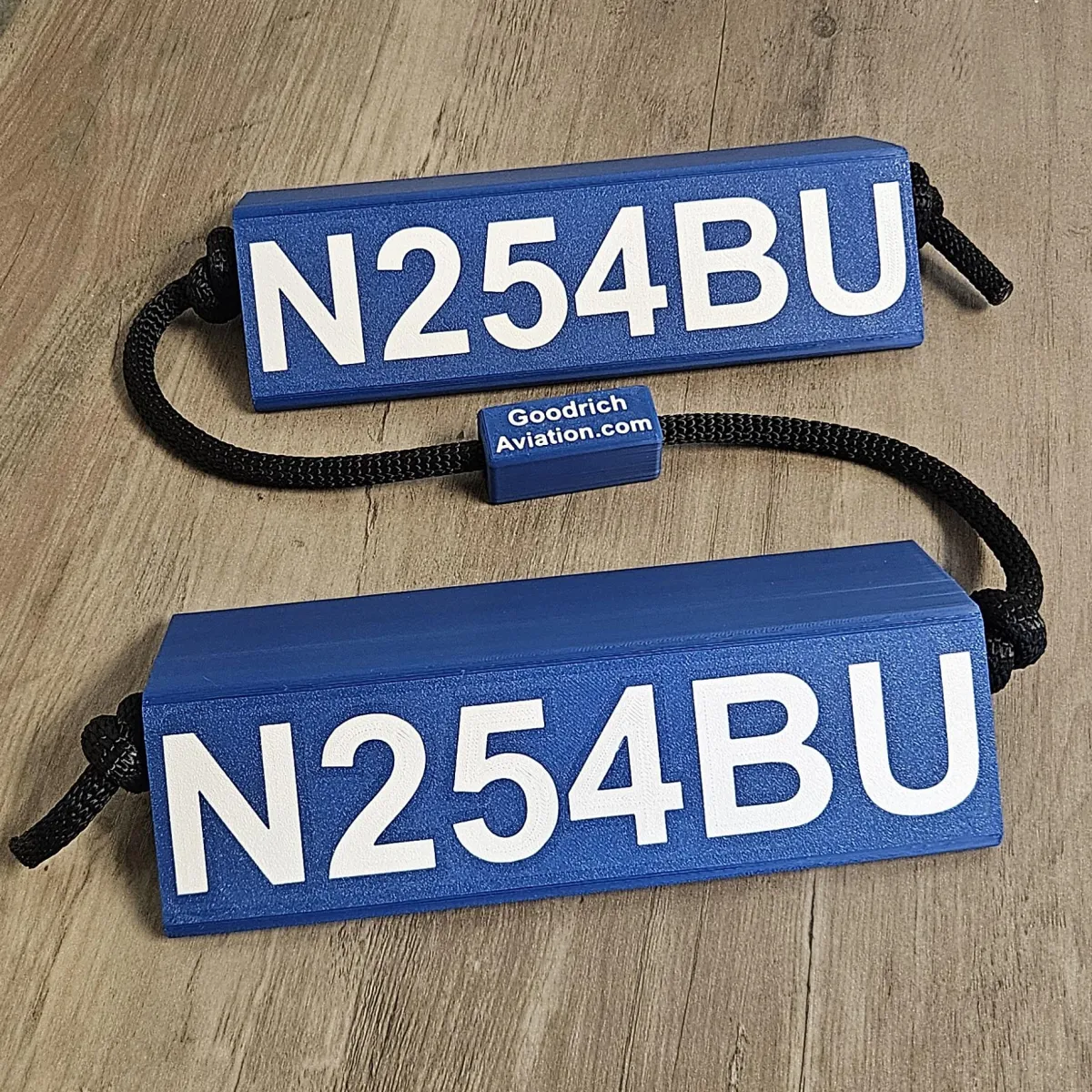Dark blue base white letters black rope