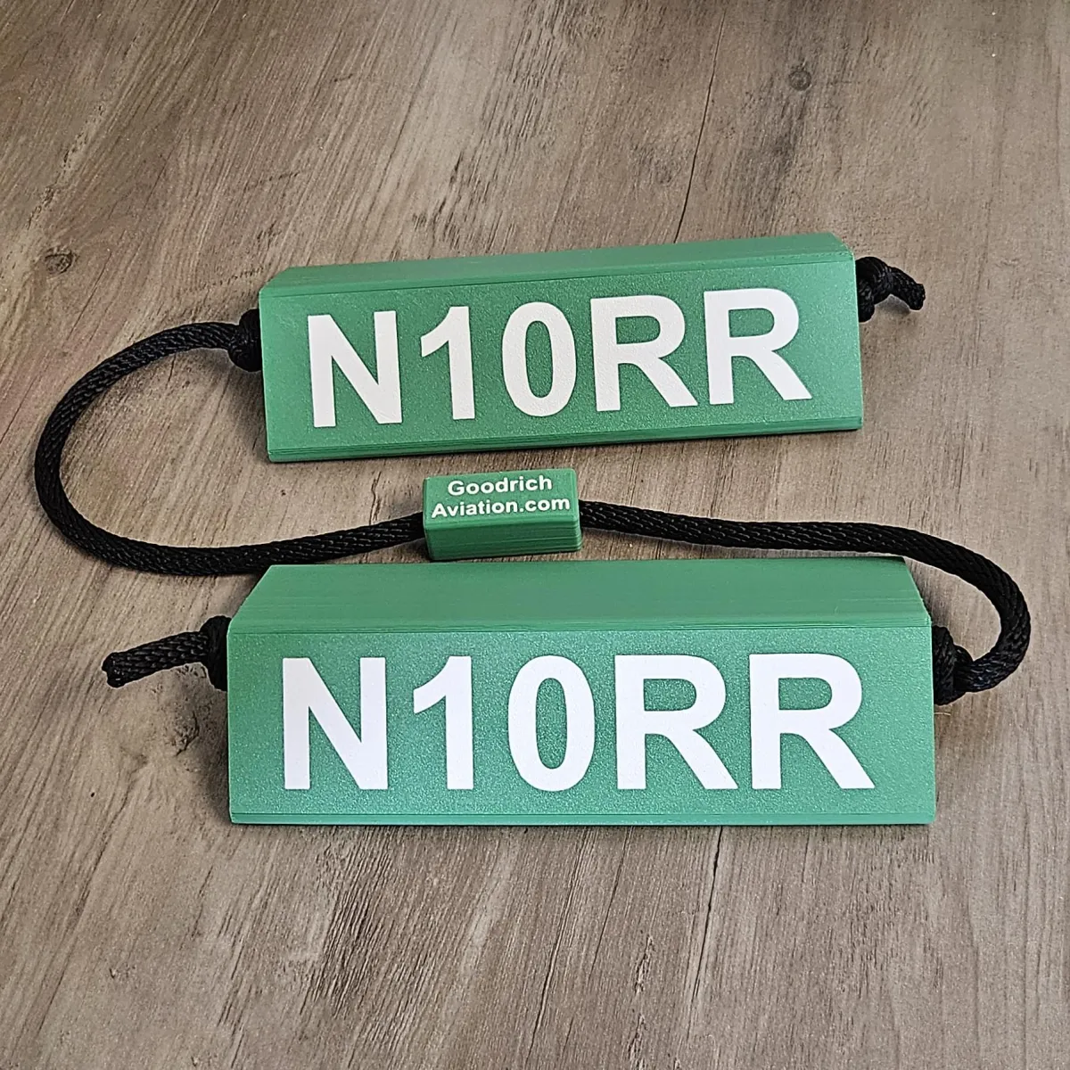 Green base white letters black rope
