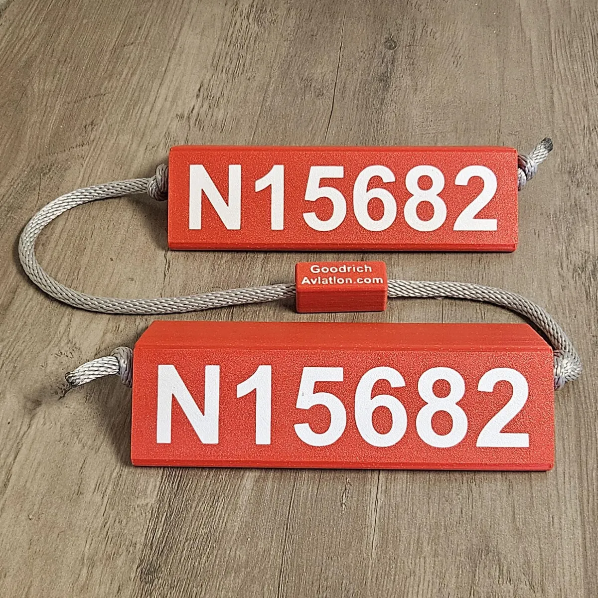 Red base white letters gray rope