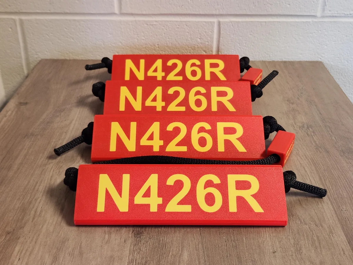 Red base yellow letters black rope