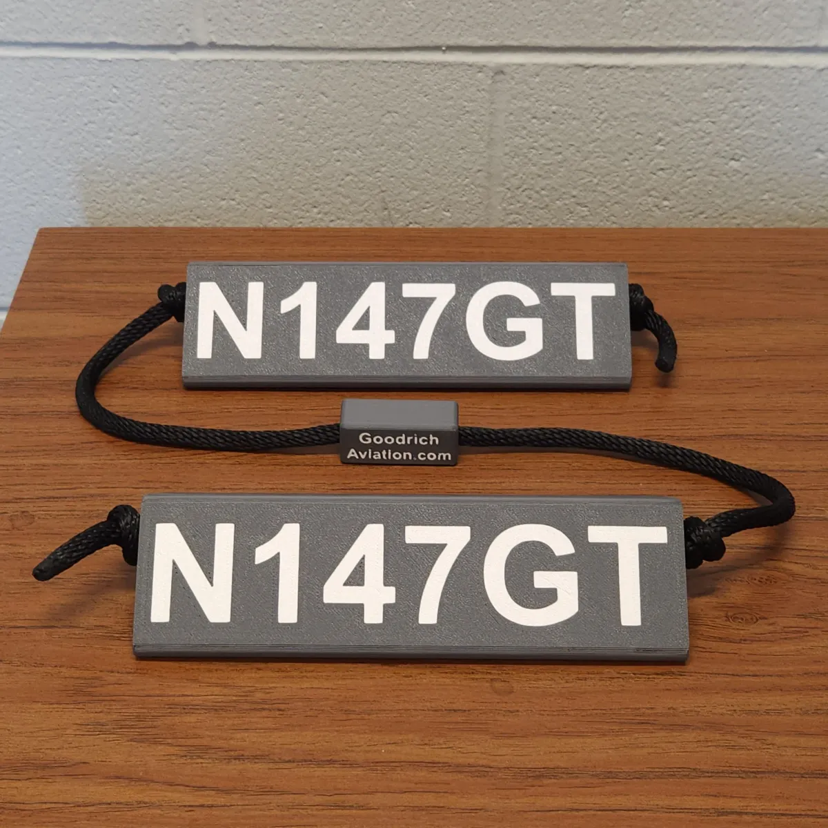 Dark gray base white letters black rope