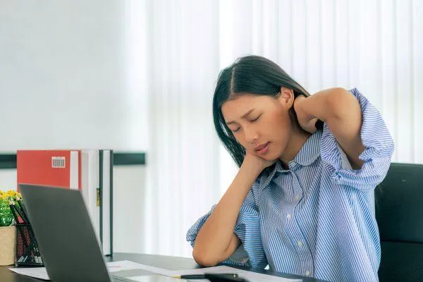 woman with neck pain at work