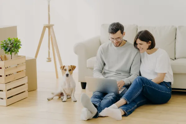 Couple reviewing security tips on a laptop at home to protect their online privacy and sensitive data.