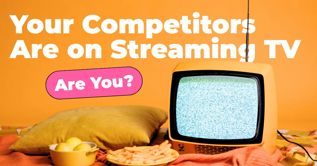 An image of an old TV with a pillow and snacks in an orange setting.