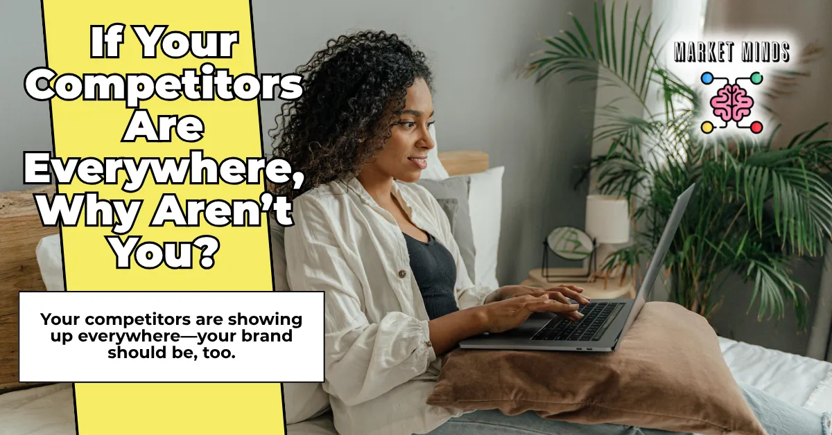 A focused woman sits on a bed, typing on a laptop, with text overlay "If Your Competitors Are Everywhere, Why Aren't You?" and "Your competitors are showing up everywhere—your brand should be, too." The Market Minds Creative logo is in the corner.