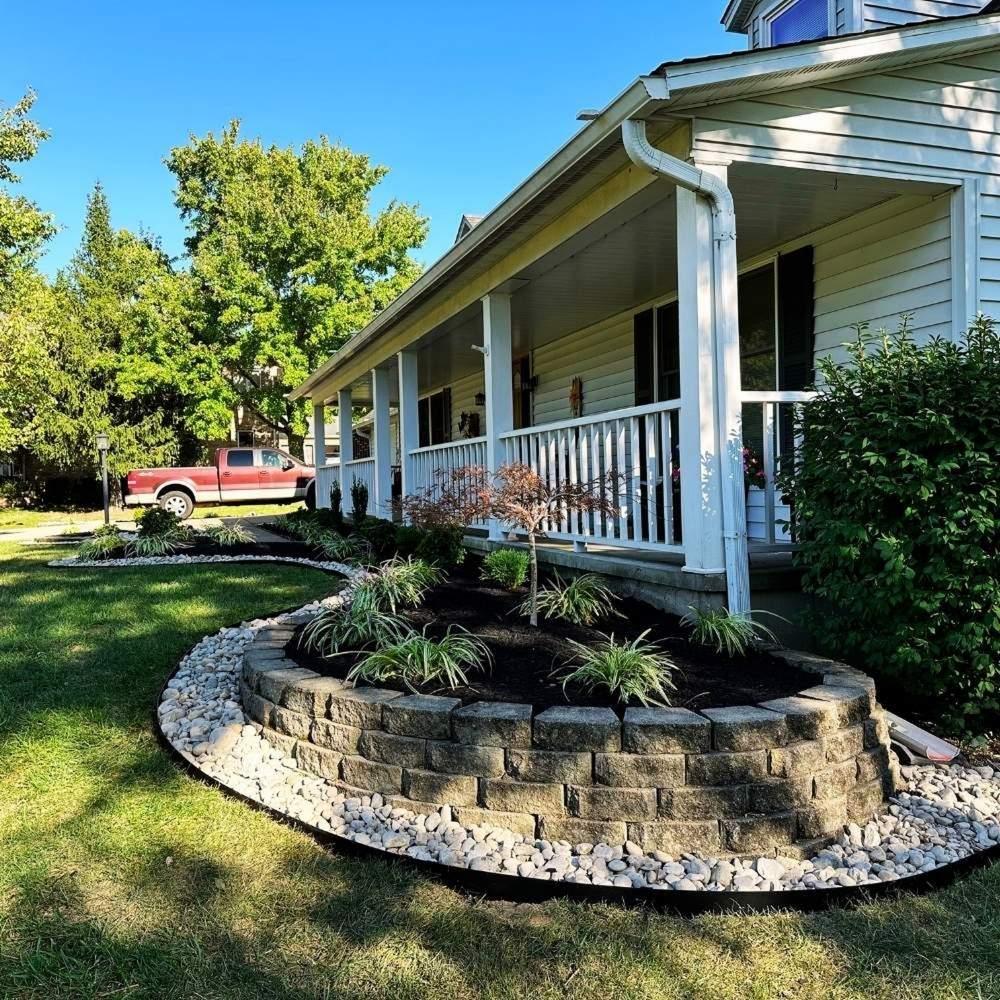 Elegant landscape design with curved walls and black mulch in Alexandria, KY.