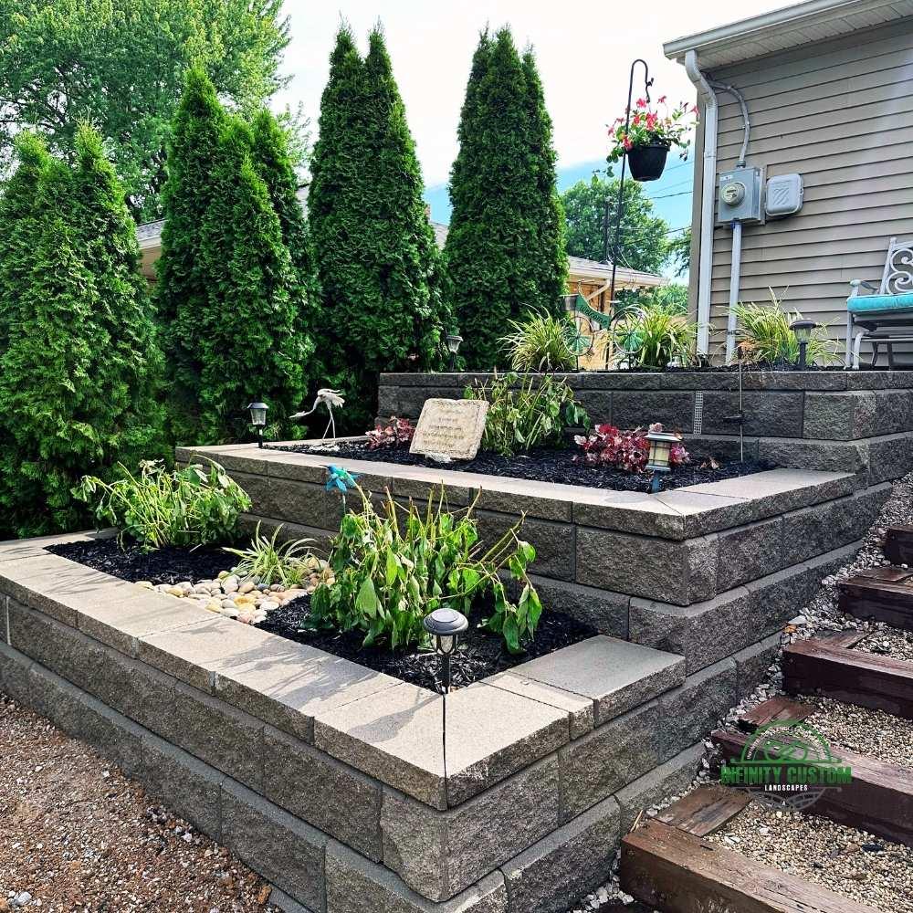 Raised garden beds with black mulch and flowers for curb appeal in Alexandria, KY.