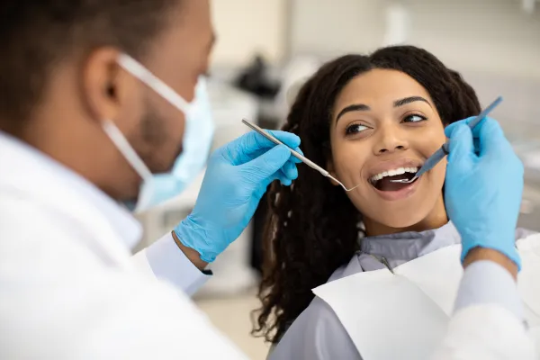 Dentist examining patient's teeth