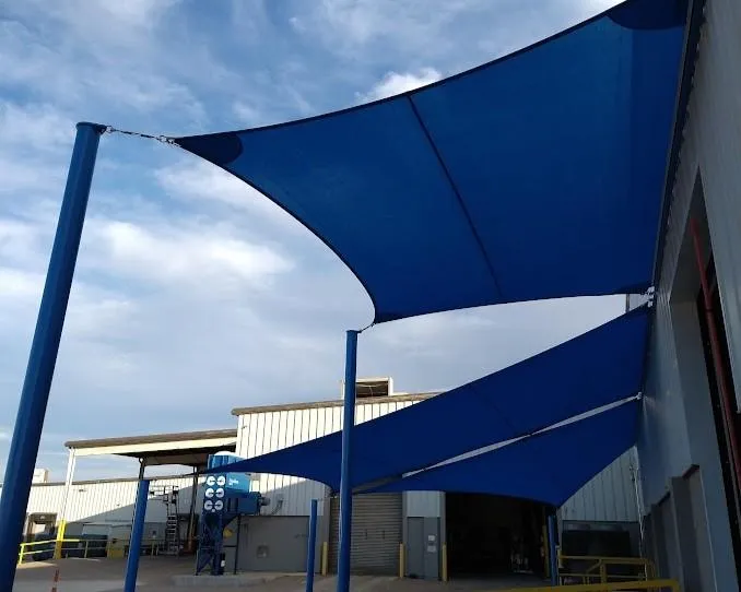 Modern shade sail installed over an outdoor space, providing stylish sun protection and coverage.