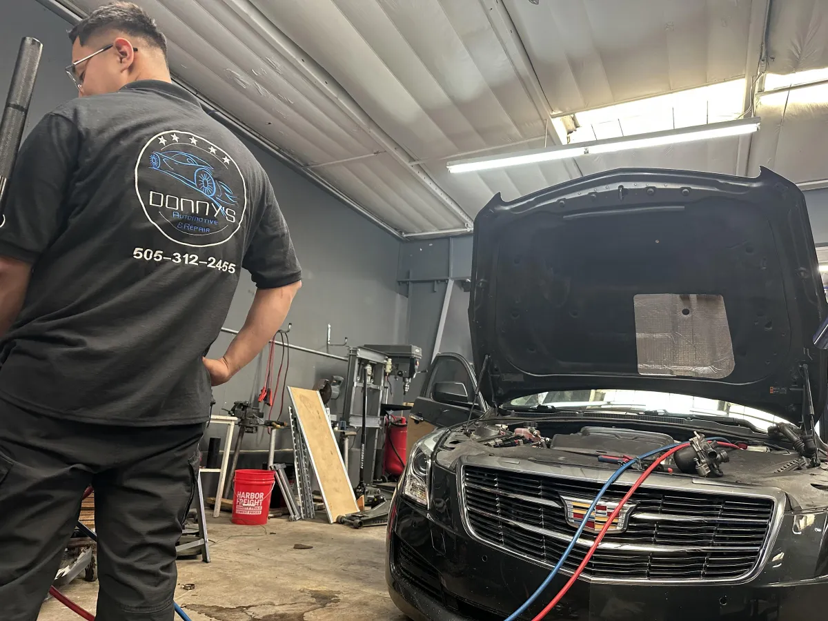 checking oil levels, and ensuring the vehicle is in peak condition. Tools and diagnostic equipment are visible, emphasizing professionalism and attention to detail."