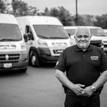 Alberto, owner of The Rooter Man SB, greeting customers from his plumbing van in Goleta.