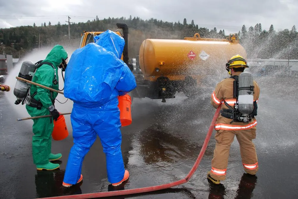 3 men wearing suits and sprinkling water like a fire fighter
