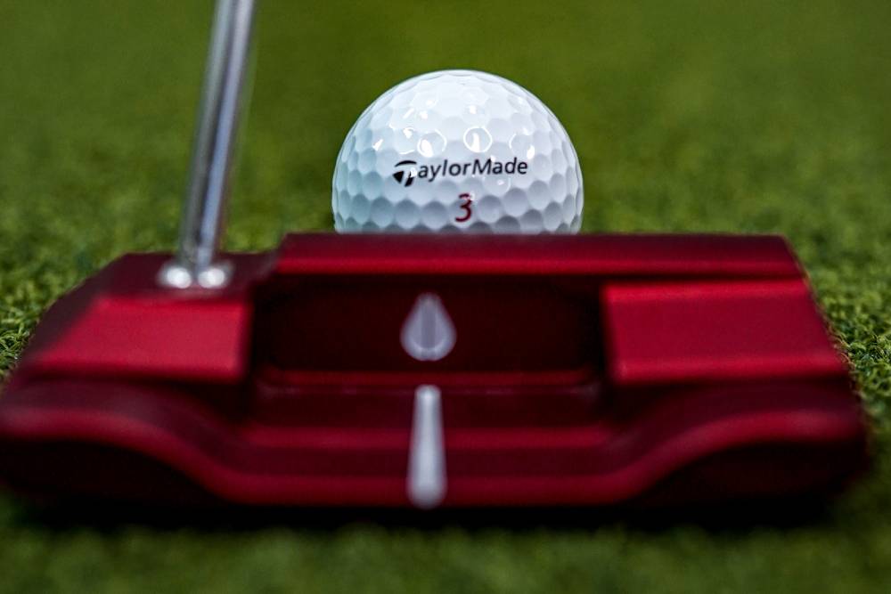 putter by golf ball