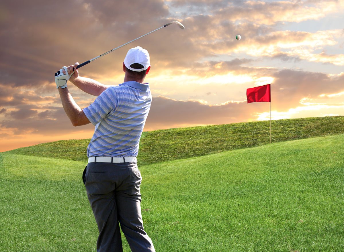 man swinging golf club