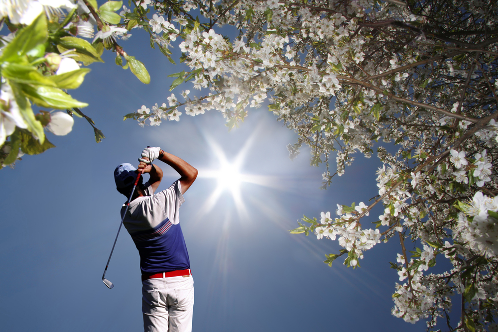 man hitting golf balls