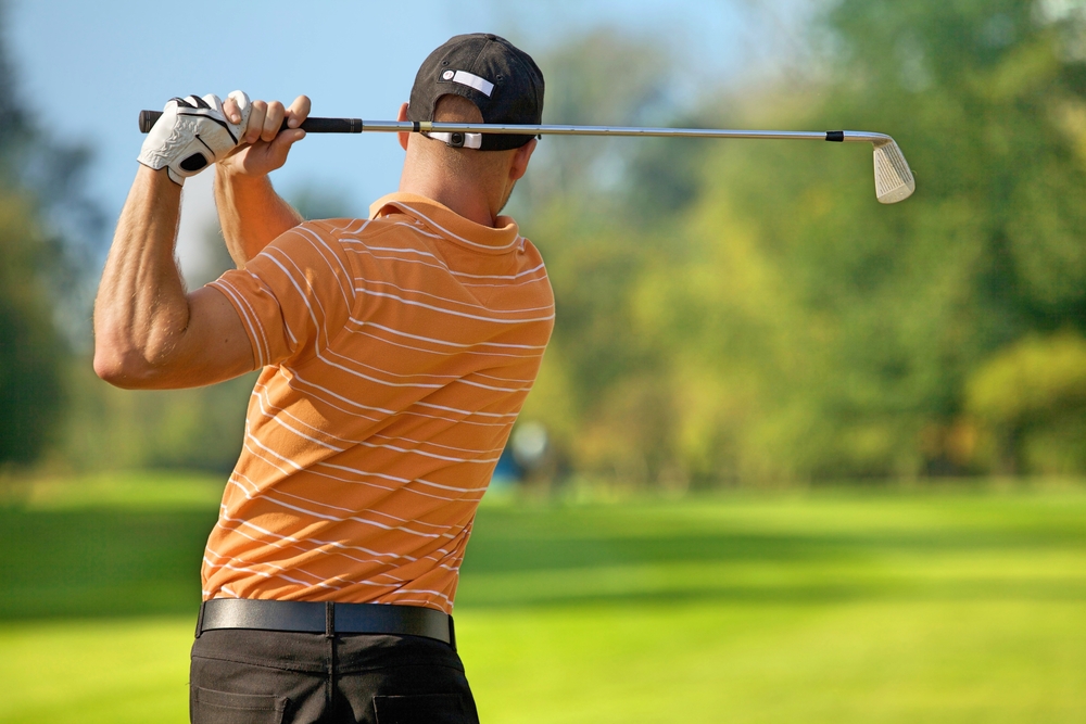 man swing golf club
