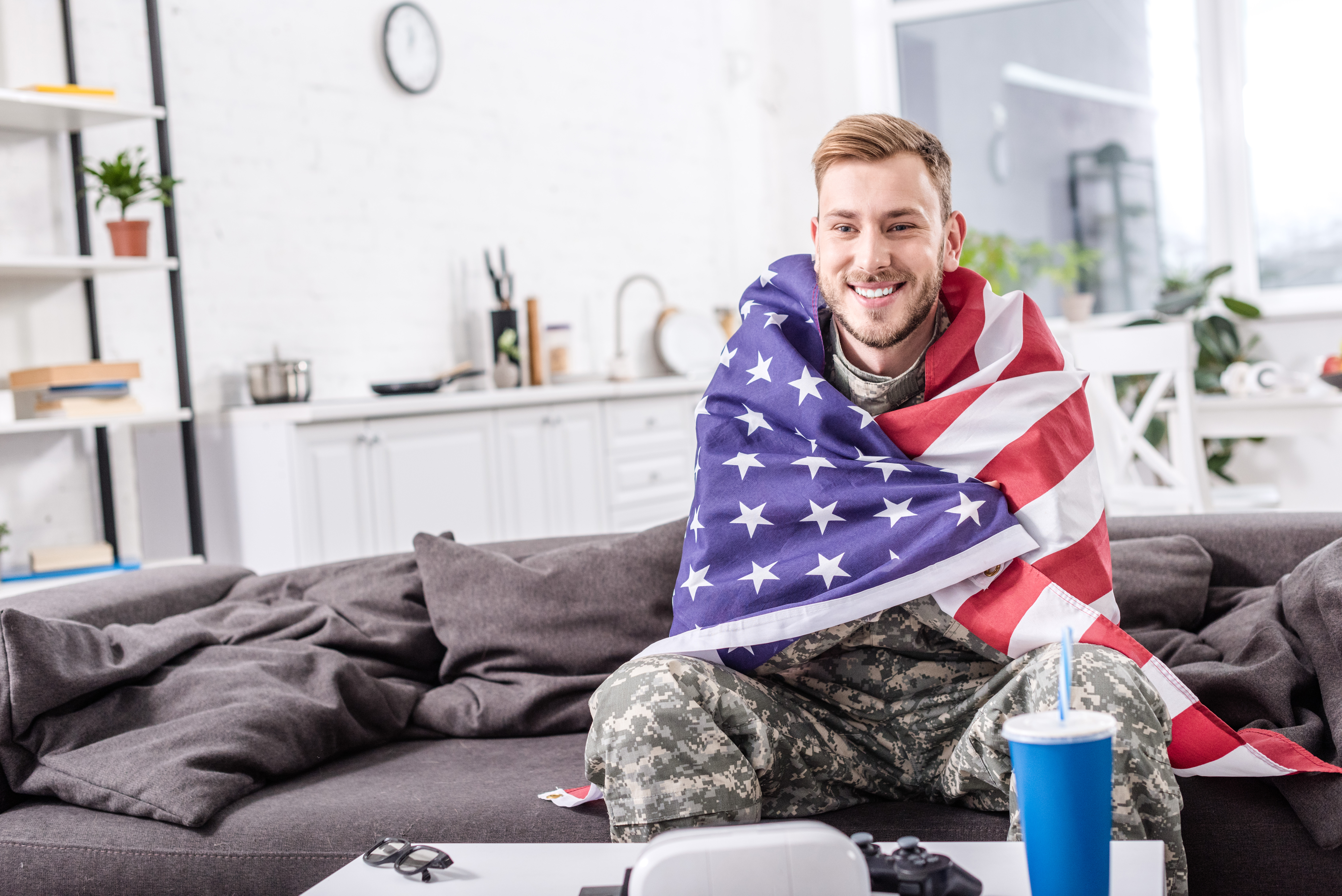 smiling army soldier covered in american flag