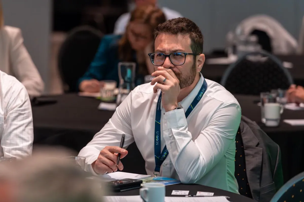 Trade mission attendee taking notes during a presentation at the Scotland-Norway Decarbonisation conference