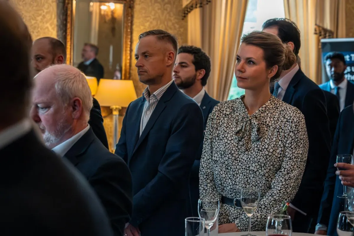 Guests gathered at the UK Ambassador's residence listening to the opening address before the networking reception