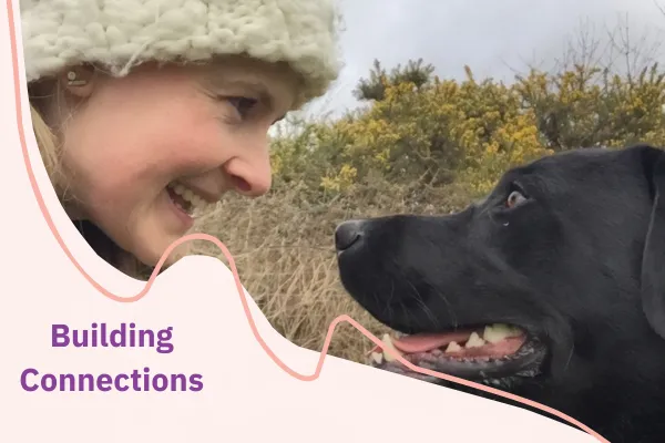 Trainer and dog looking contently at each other.