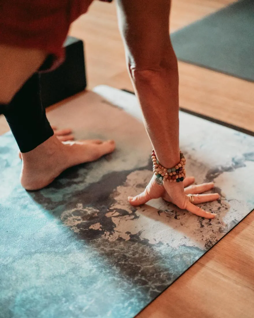 Person performing Reverse Plank with one leg lifted, hips elevated, showing strength and balance on a yoga mat.