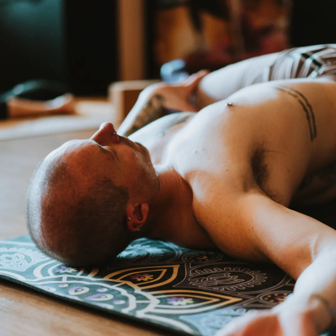 Young person holding a standing yoga pose with calm focus in a natural outdoor setting, symbolizing inner patience and mindfulness cultivated through yoga.