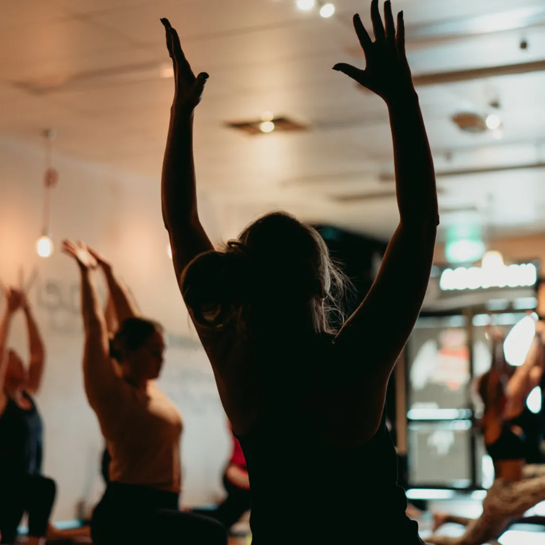 Person practising calm breathing or meditation amid a busy environment, symbolising anxiety management and inner steadiness.