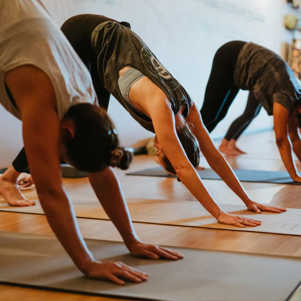 Person seated in a peaceful meditation pose on a yoga mat, eyes closed and breathing steadily, representing impermanence, acceptance, and navigating change.