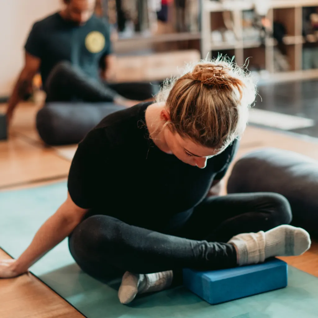 Person holding a strong Warrior II yoga pose with steady gaze and calm breath, representing inner strength and resilience during uncertain times.