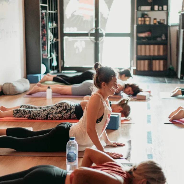 Yoga student seated in meditation with calm facial expression in a softly lit studio, representing emotional intelligence, inner awareness, and self-regulation through yogic practice.