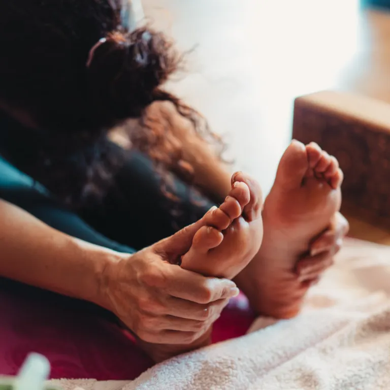 Yoga practitioner seated in Staff Pose (Dandasana), demonstrating upright posture, core engagement and spinal alignment.