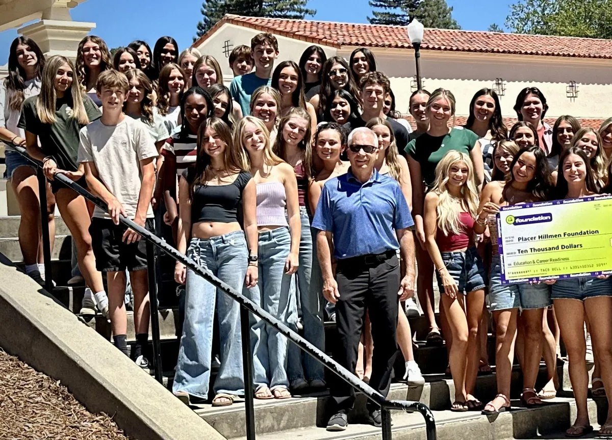 Placer 1974 grad and area Taco Bell franchise owner Gary Lyon (center) presented $10,000 to the Hillmen Foundation from the Taco Bell Foundation.
