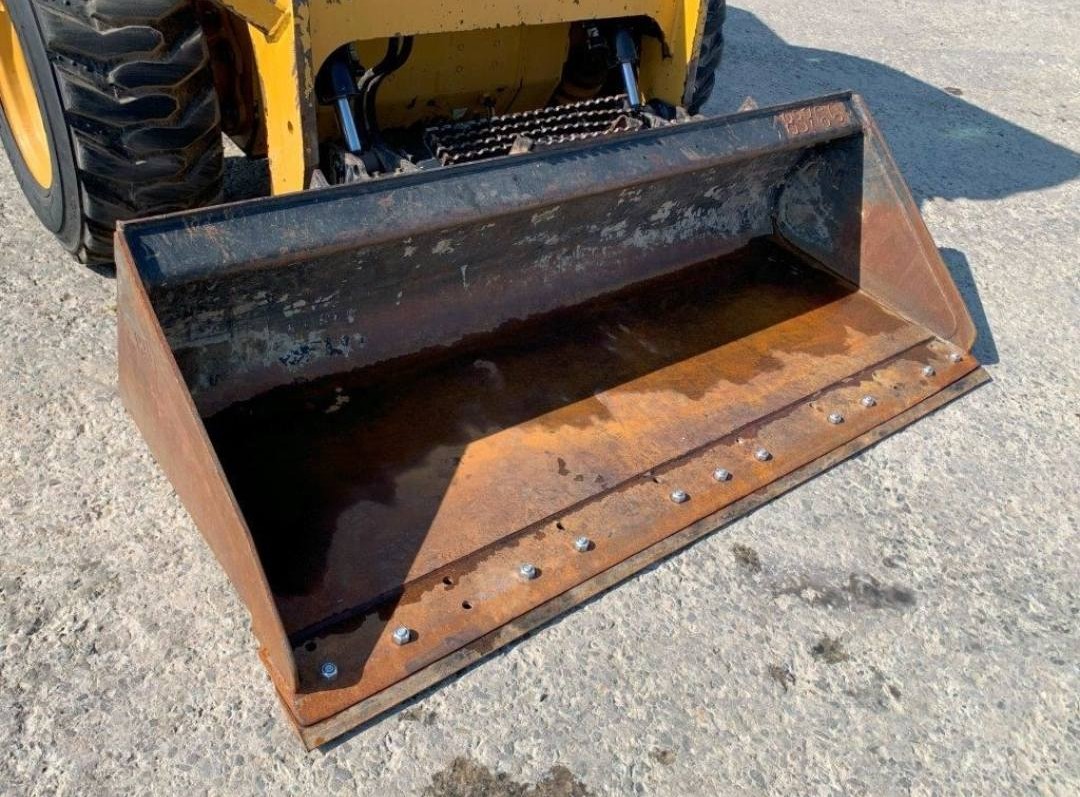 CAT 246D equipment bucket attachment showing wear and operational capability