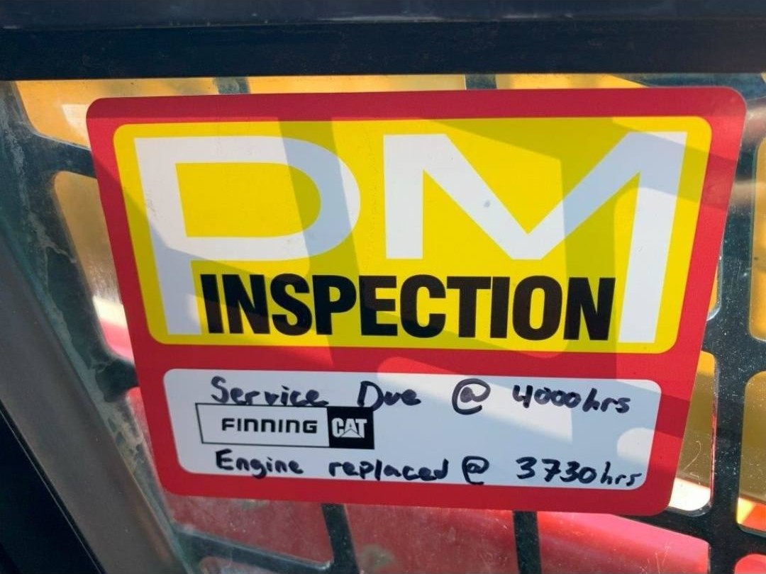 CAT 246D equipment inspection certification label with maintenance documentation