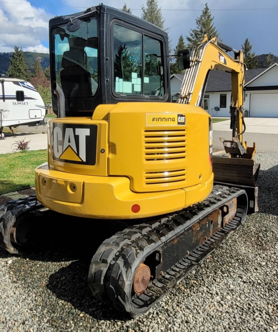 CAT 305.5 excavator operator cab interior showing comfortable seating and hydraulic controls