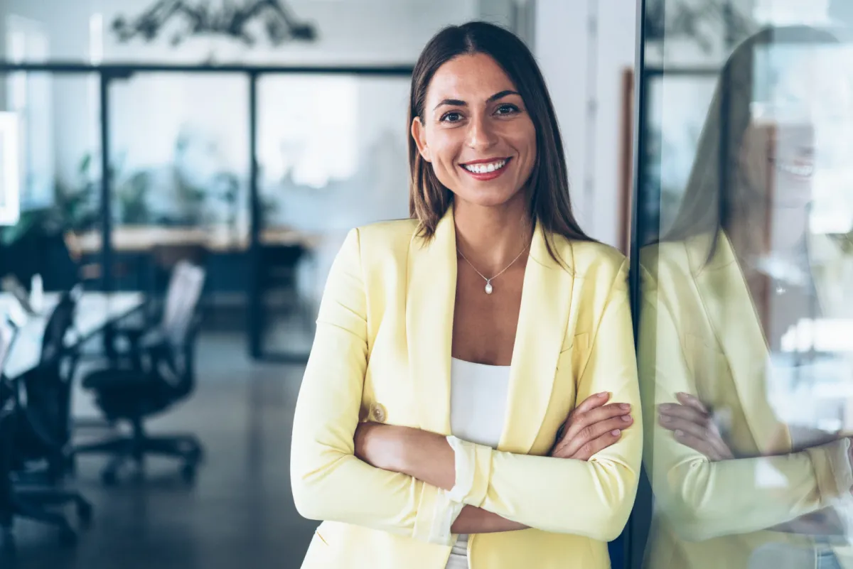 Confident hispanic business woman in yellow blazer