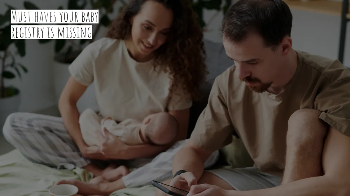 Mom holding baby while Dad shops for last minute baby items on his phone.