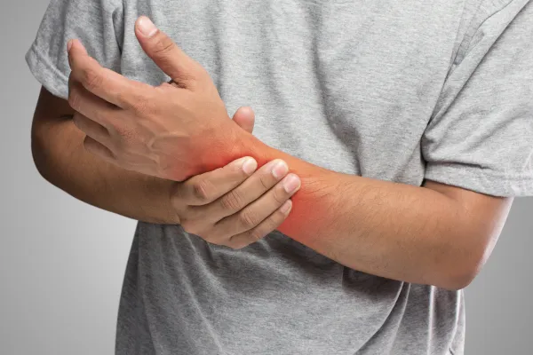 man holding his hand in pain blog post cover
