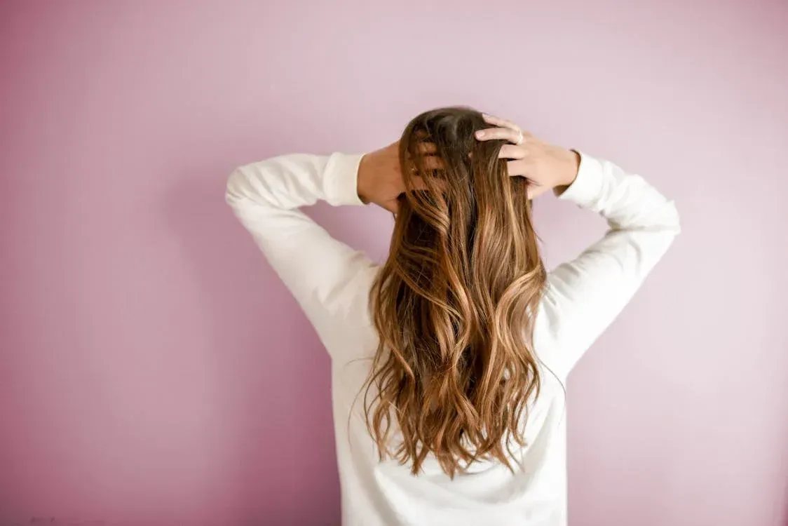 women holding her hair, new hair extensions in sherman texas